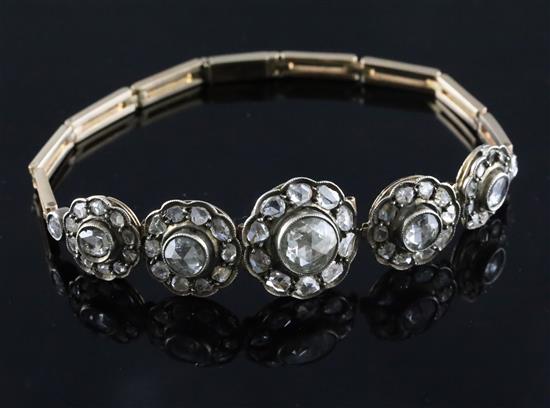 An antique gold and graduated quintuple diamond cluster set bracelet (a.f.),